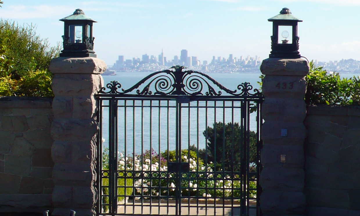 Iron gate with city view through it.