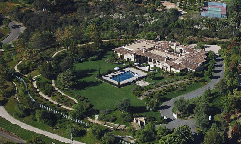 Aerial view of a large-house with a pool.