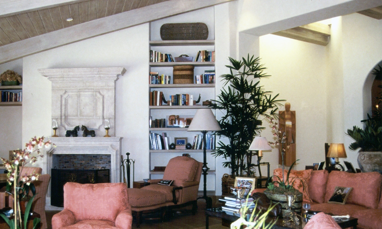 Living room with fireplace and bookshelves.