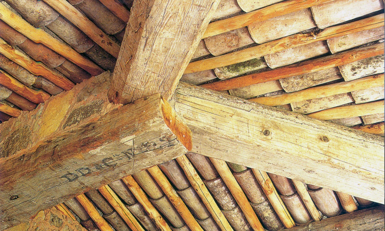 Close-up of wooden beams and roof tiles.